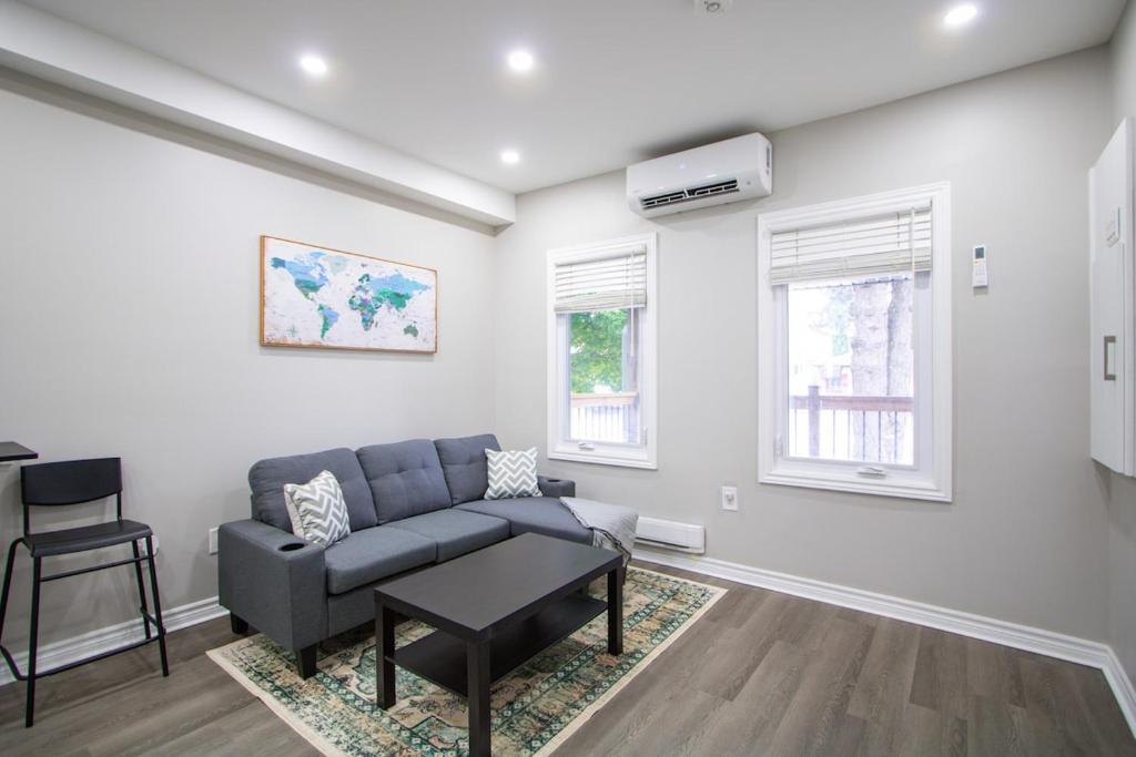 a living room with a couch and a table at Cozy Downtown London 1BR Gem in London