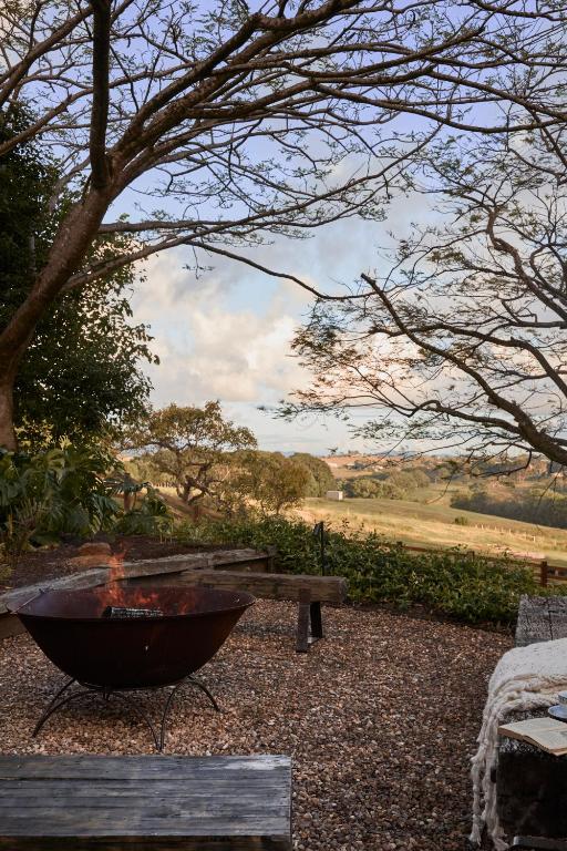 a fire pit sitting next to a picnic table at Meadows Byron in Bangalow