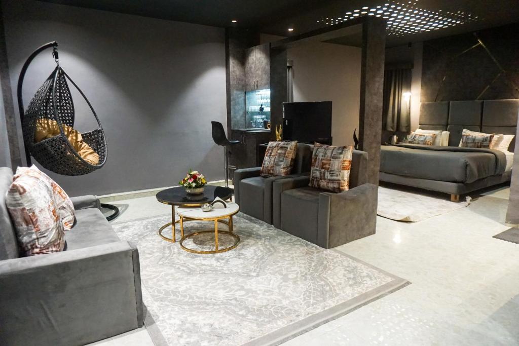 a living room with couches and a table at The Havelock Hotel, Vijay Nagar in Indore