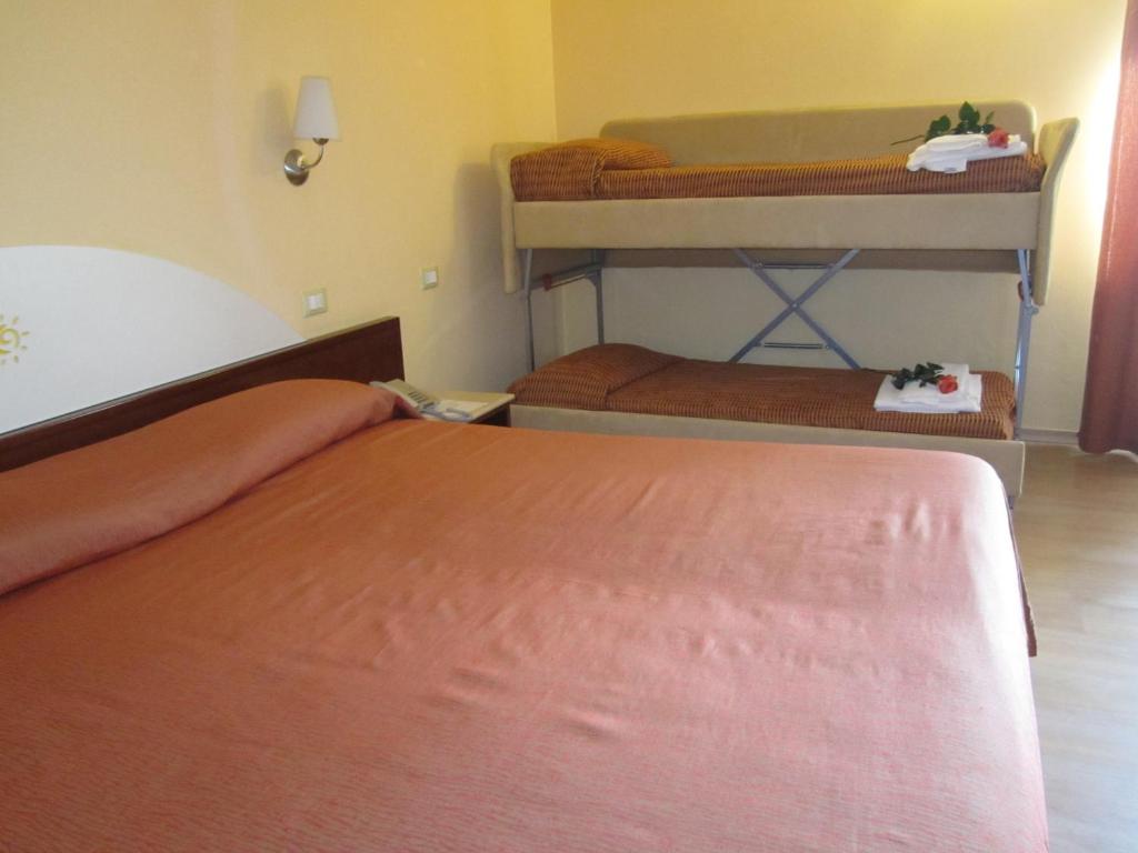 Postel nebo postele na pokoji v ubytování Hotel Al Sole - ENJOY HOLIDAY