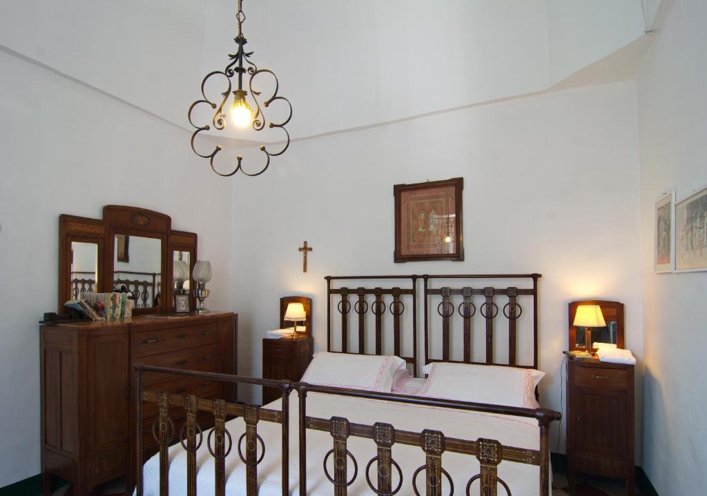 a bedroom with a bed and a chandelier at Masseria Il Frantoio in Ostuni