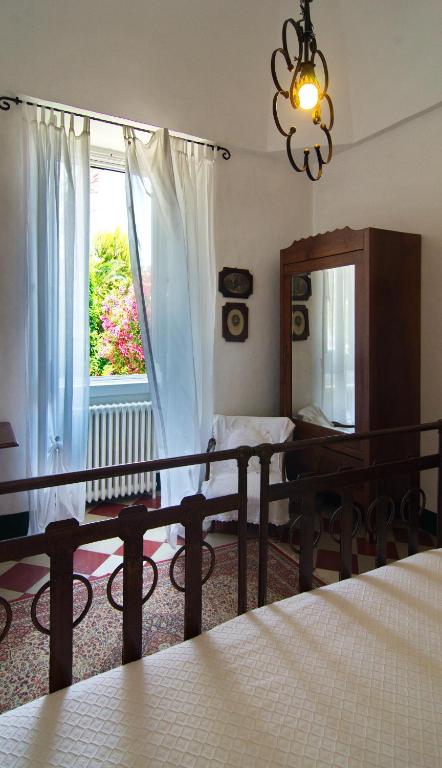 a bedroom with a bed and a mirror and a window at Masseria Il Frantoio in Ostuni