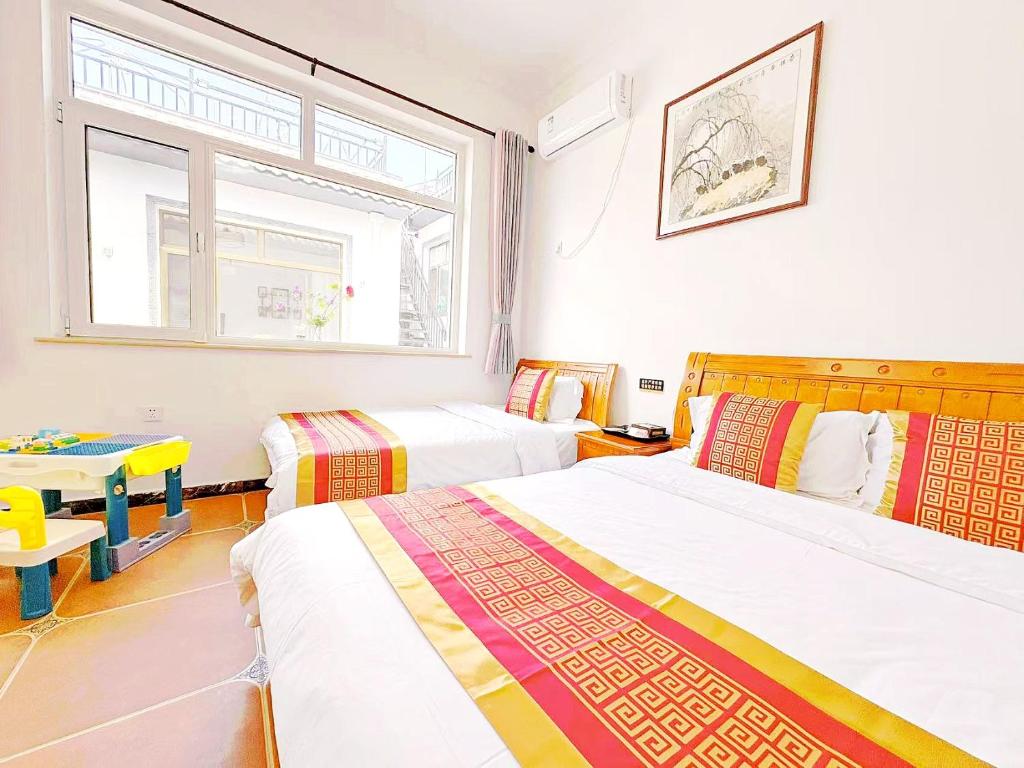 Postel nebo postele na pokoji v ubytování Beijing Great Wall Shiguang Homestay