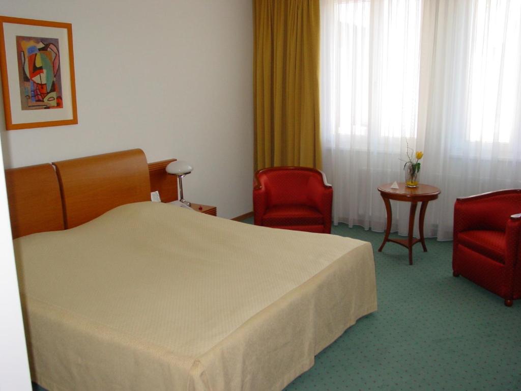 Postel nebo postele na pokoji v ubytování Hotel Exel