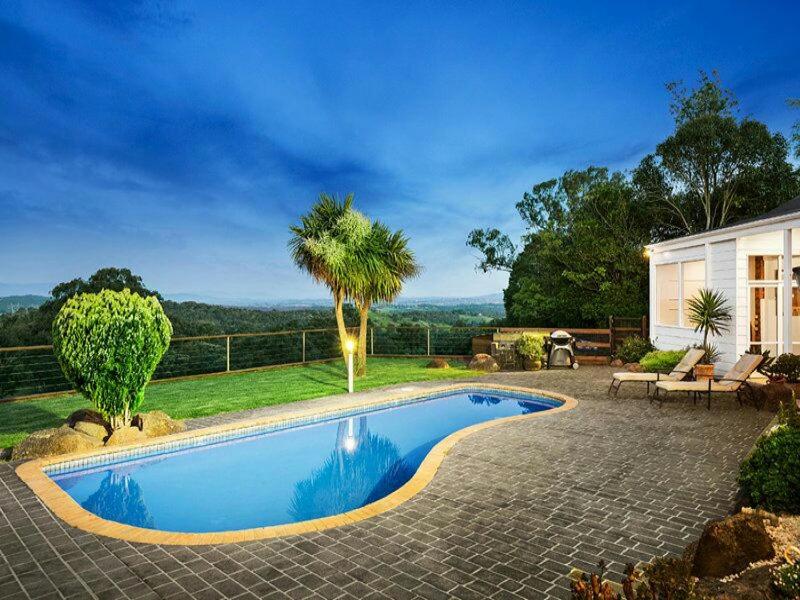 a swimming pool in front of a house at 410 Kangaroo ground 15 , 20 people restaurant in Kangaroo Ground