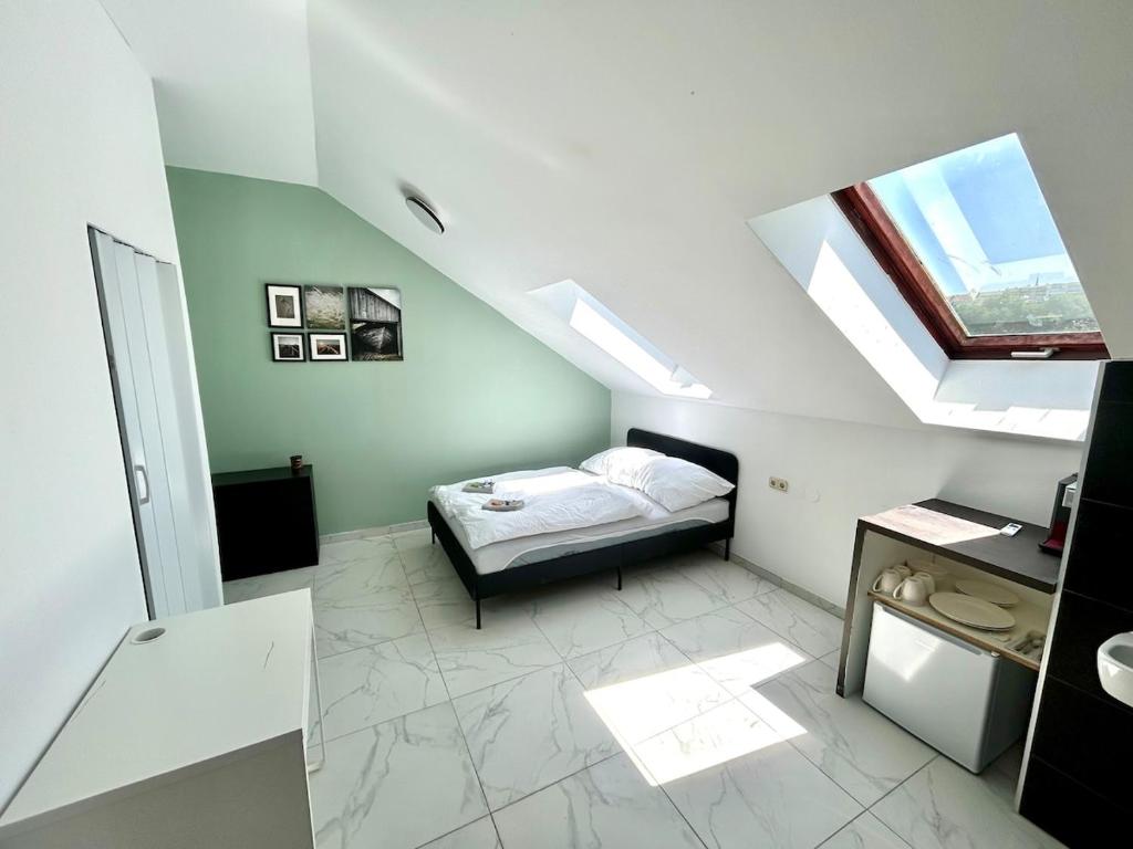 a small bedroom with a bed and a skylight at HONOR - Perfect for 2 in Linz