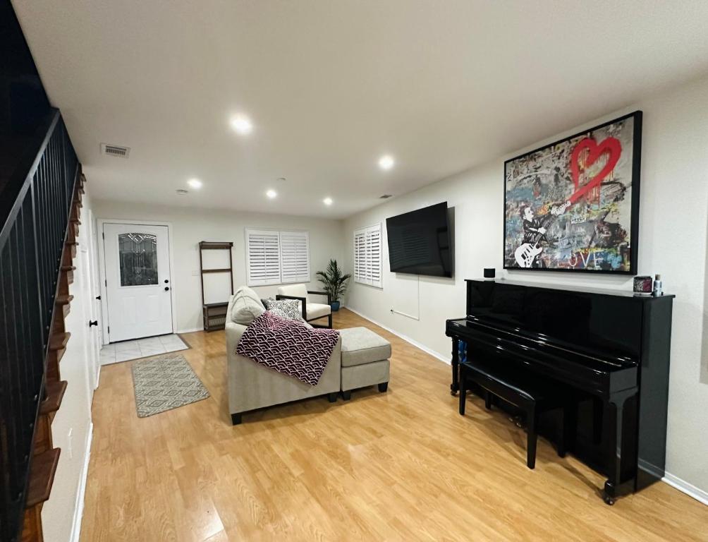 a living room with a piano and a couch at Echo House in Los Angeles