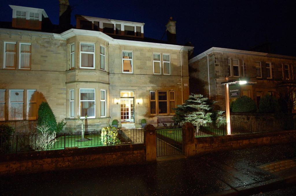 a house with a fence in front of it at night at Inverlea Guest House in Ayr