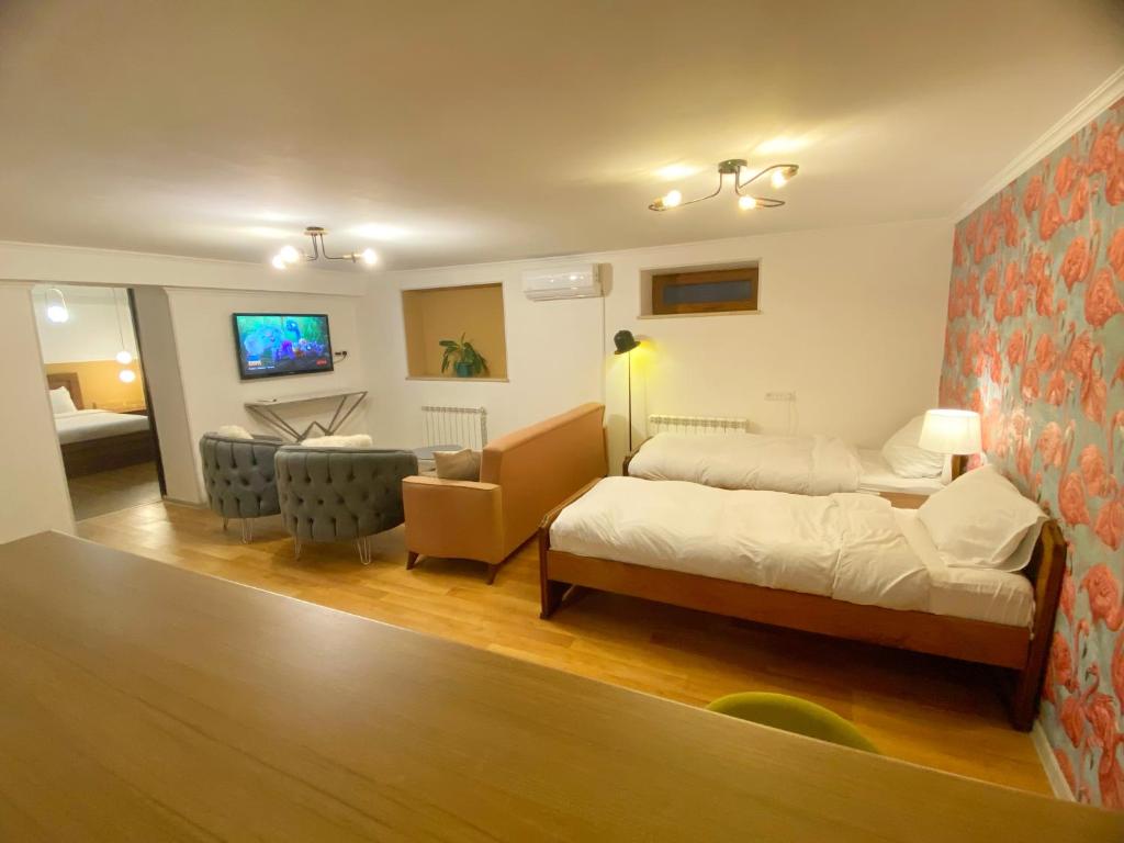Postel nebo postele na pokoji v ubytování Hotel Orange Kutaisi