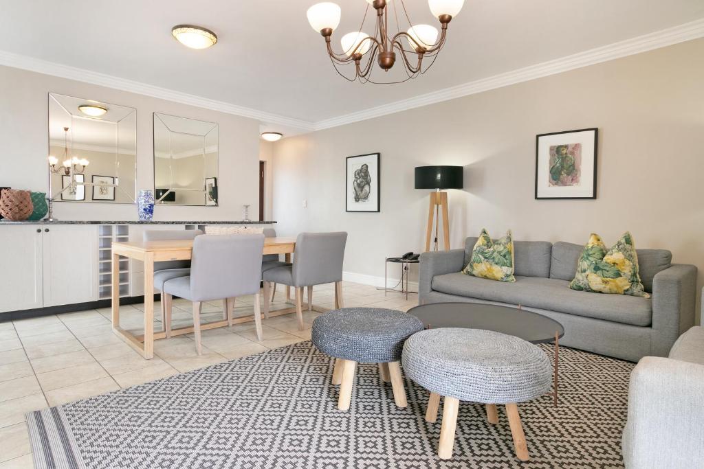 a living room with a couch and a table at Winelands Golf Lodges 12 in Stellenbosch