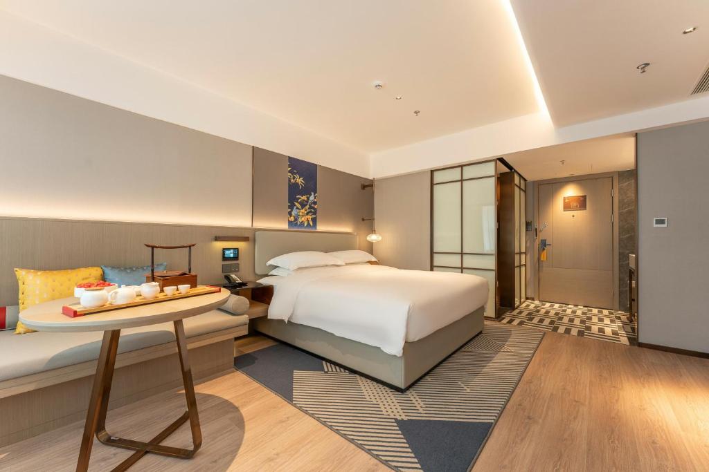 Ένα ή περισσότερα κρεβάτια σε δωμάτιο στο Yicheng Hotel, Jianghan Road Pedestrian Street, Wuhan River Beach