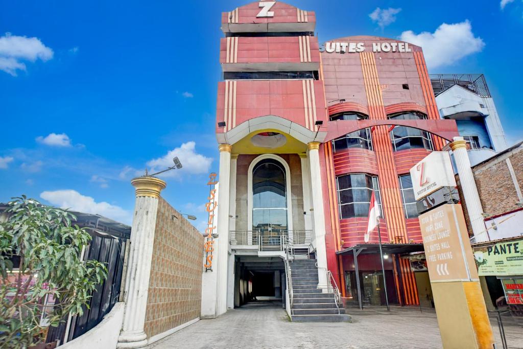 a red building with a staircase in front of it at Hotel Grand Z Suites 6 Hour Stay in Medan