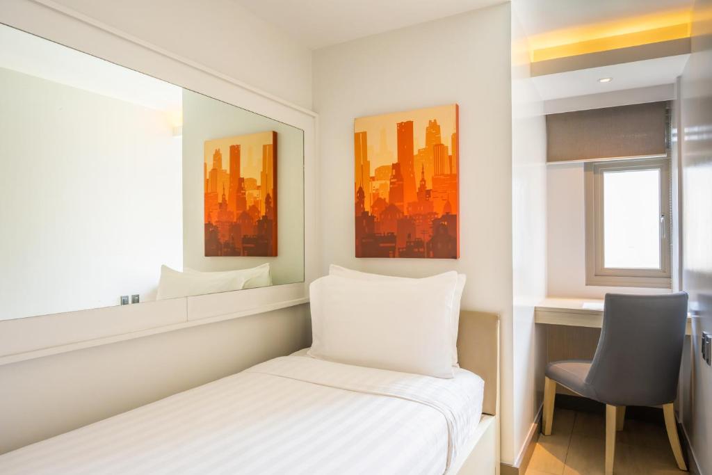 Postel nebo postele na pokoji v ubytování The Mini Suites Eton Tower Makati