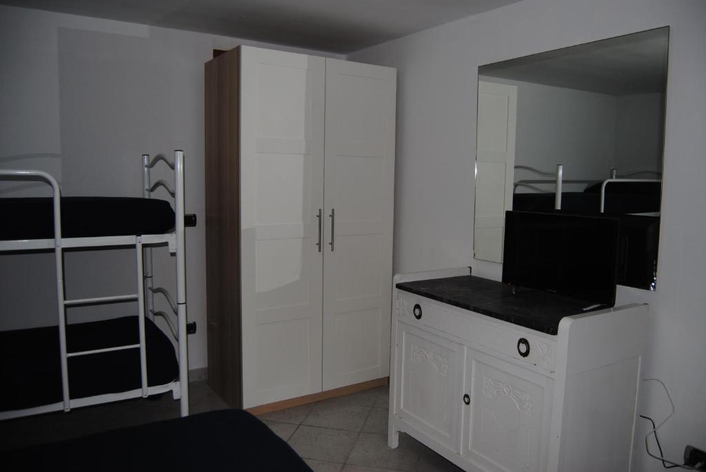 a bedroom with two bunk beds and a desk with a television at Il Susino in Tirrenia