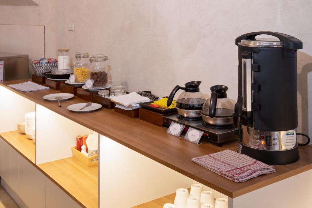 A self-service drinks and snacks counter with coffee and hot-water equipment.