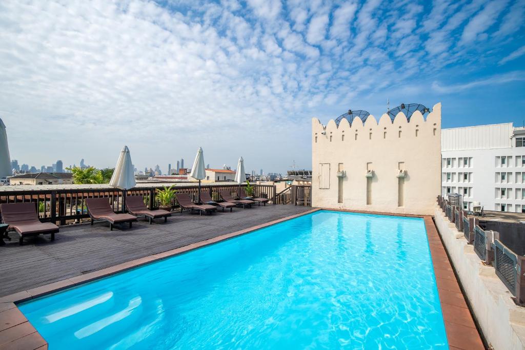 a swimming pool on the roof of a building at Dewan Bangkok in Bangkok