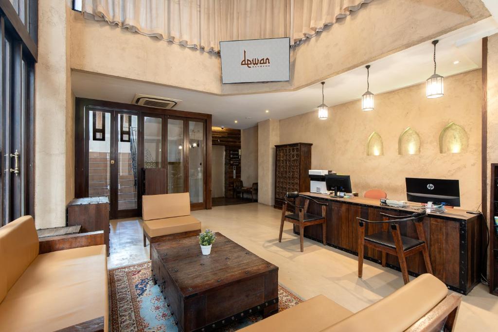 A reception lounge combining a check-in desk with sofas and armchairs.