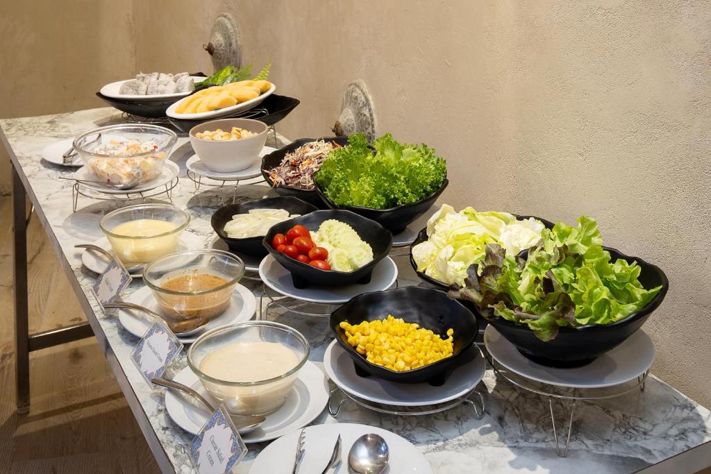 A marble-topped breakfast spread of salads, fruit and accompaniments.
