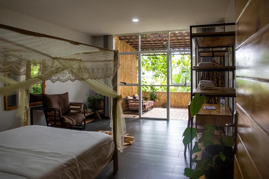 a bedroom with a bed and a view of a patio at Eagle View Lodge - Kigali in Kigali