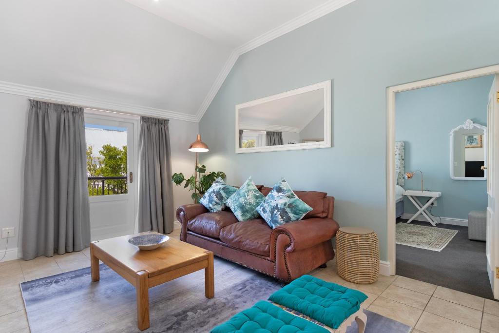 a living room with a couch and a table at Winelands Golf Lodges 40 in Stellenbosch