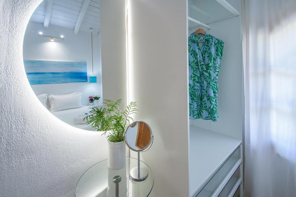 a bathroom with a mirror and a table with a plant at Georgia Villas in Skiathos