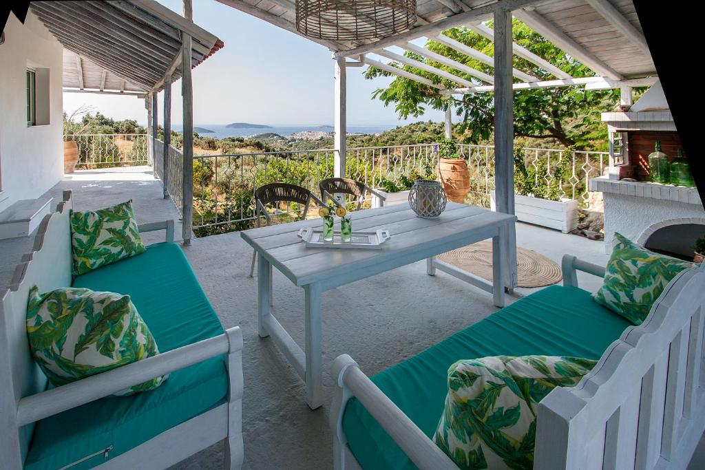 a table and chairs on a patio with a view at Georgia Villas in Skiathos