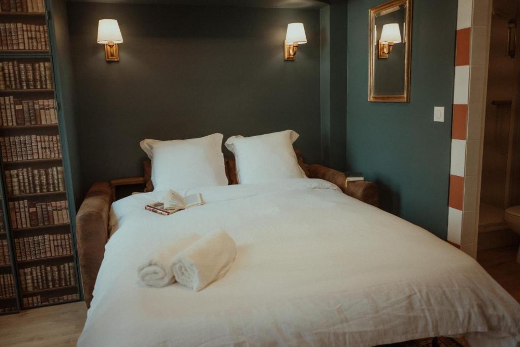 une chambre avec un lit avec des serviettes dessus dans l'établissement Victor Hugo, à Besançon