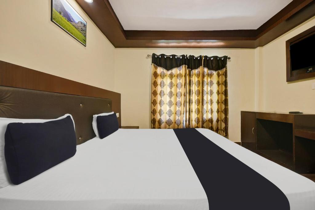 Postel nebo postele na pokoji v ubytování Hotel O Tridev