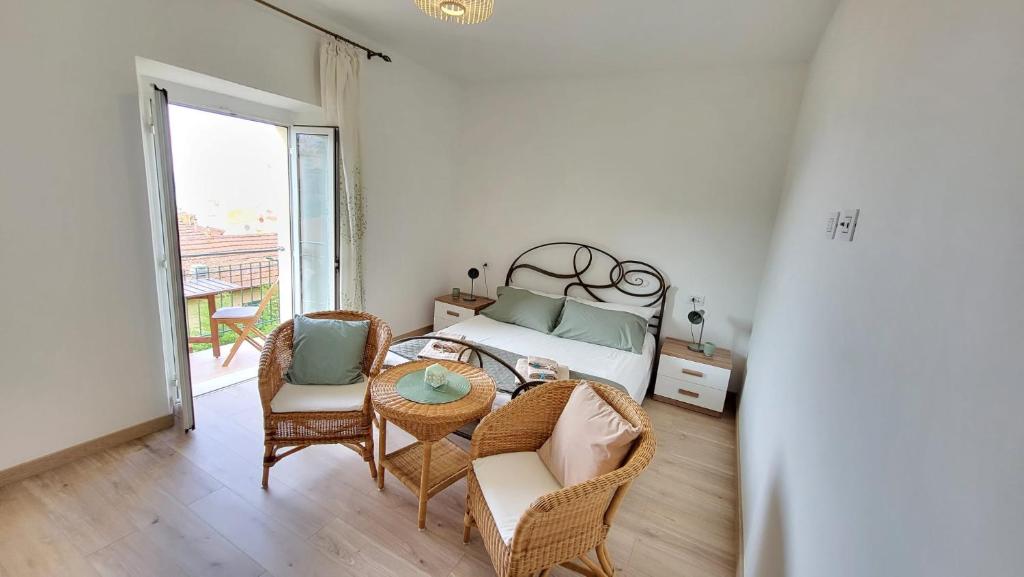 a bedroom with a bed and a table and chairs at Nima in Porto Santo Stefano