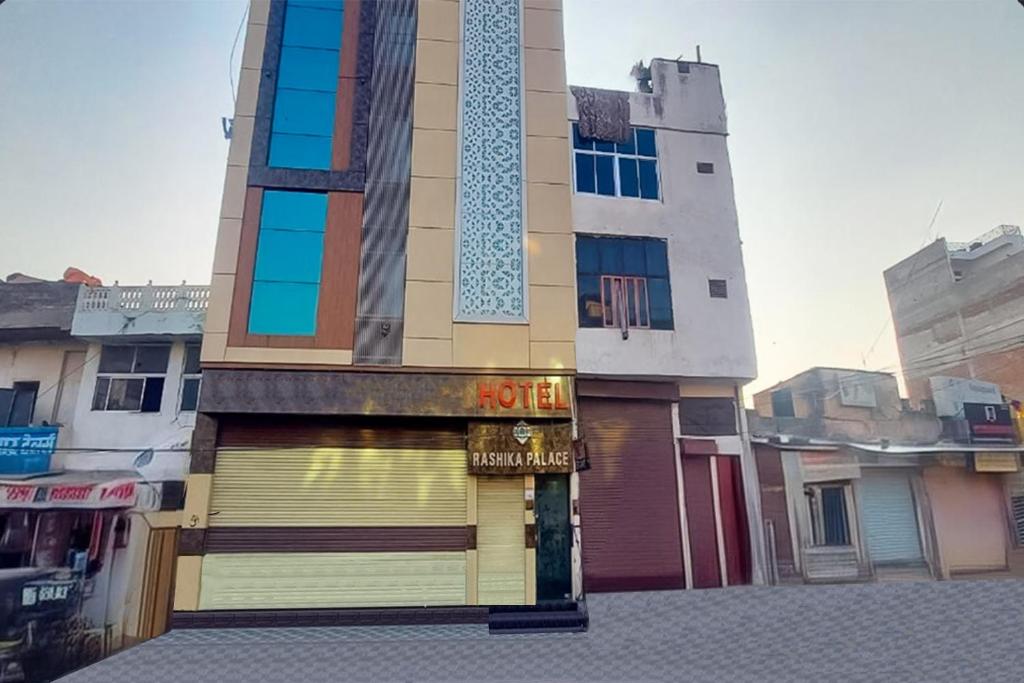 a building with a sign on the front of it at Hotel Rashika Palace Near Sindhi Camp Bus Stand, Jaipur in Jaipur