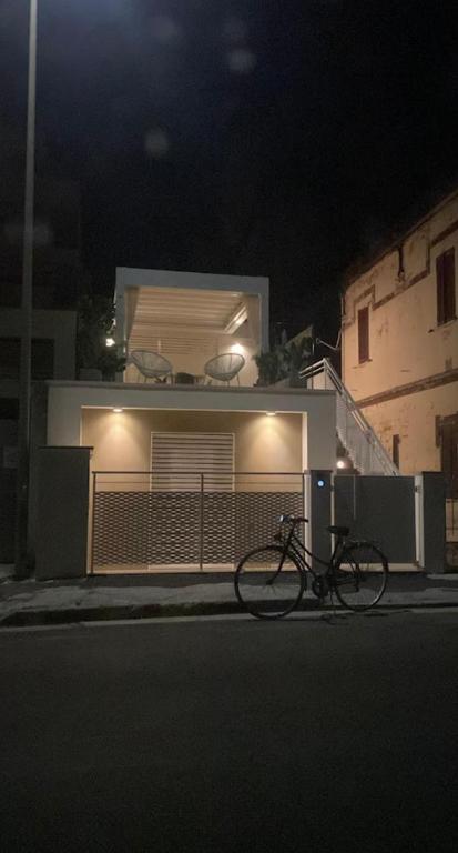 a bike parked in front of a house at night at aMare Senigallia in Senigallia