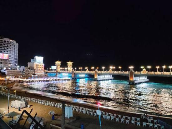 a bridge over a body of water at night at القاهرة in New cairo