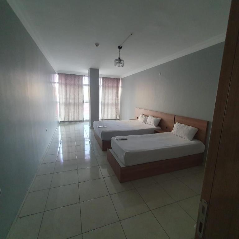Postel nebo postele na pokoji v ubytování Rosse Hotel