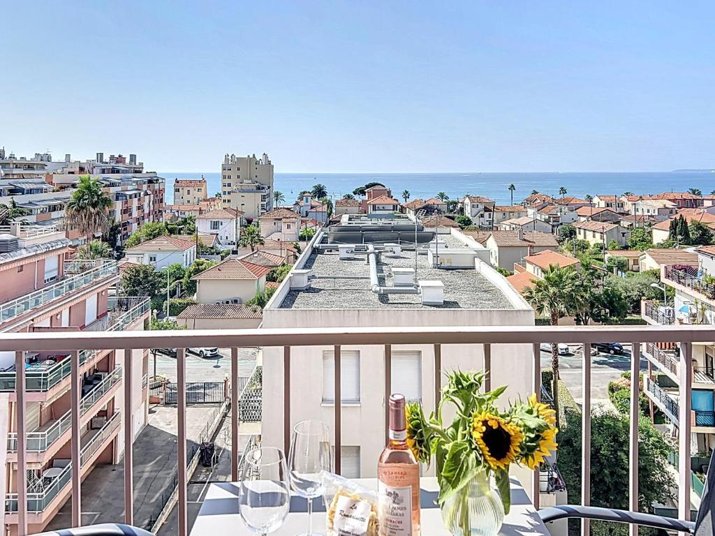 a balcony with a table and a view of a city at Azur in Cagnes-sur-Mer