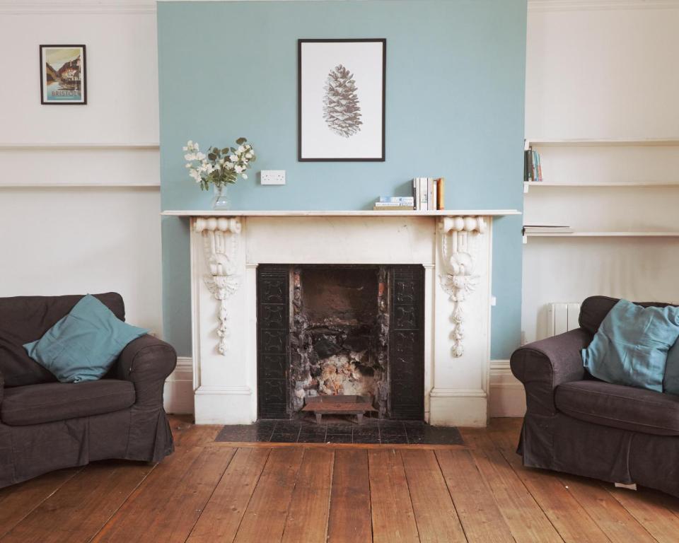 a living room with two couches and a fireplace at Georgian Shared House No'64 - By Clifton Short Lets in Bristol
