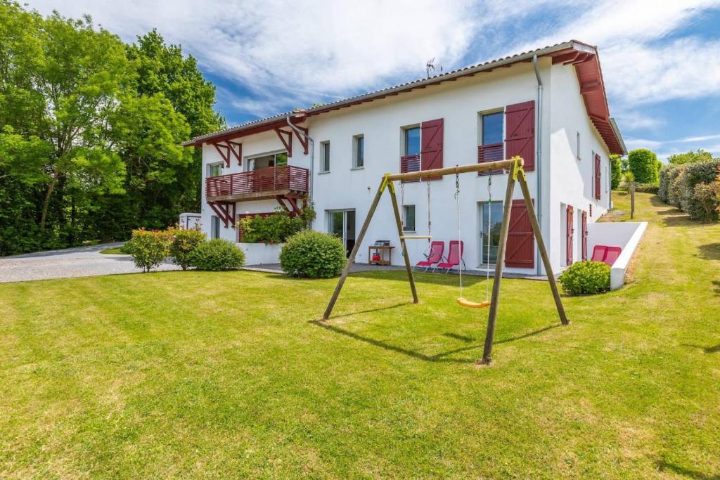 a house with a yard with a swing at Haritza in Ahetze