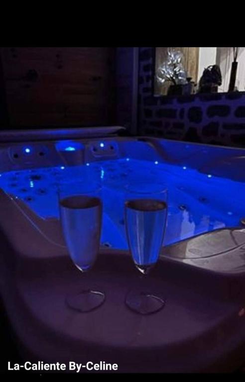 two wine glasses sitting on top of a table at la caliente in Saint-Mars-sur-la-Futaie