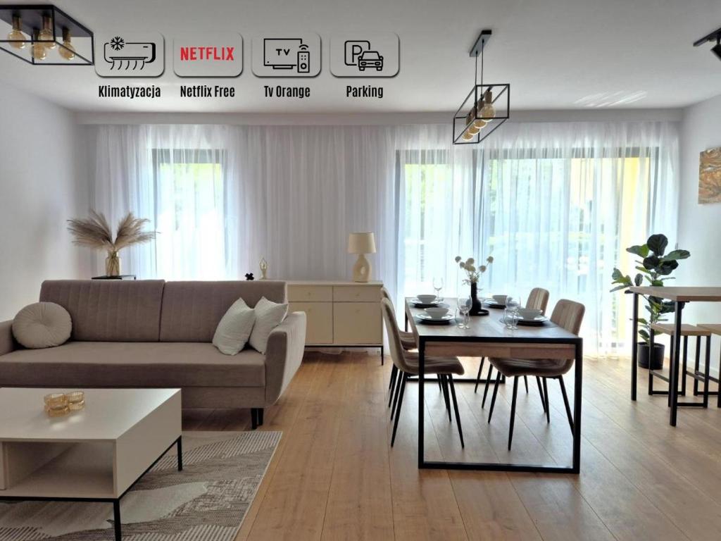 a living room with a couch and a table at Willa Racławicka Apartments in Poznań