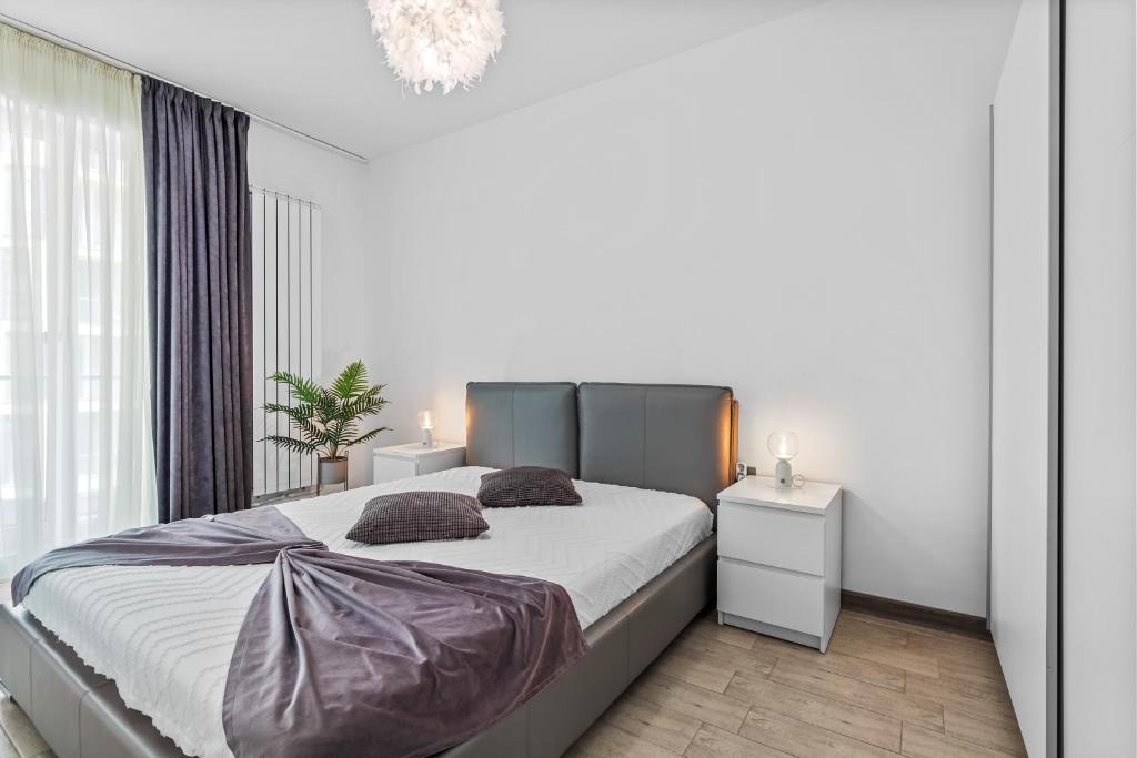 En eller flere senge i et værelse på Divin Apartments Beach Resort