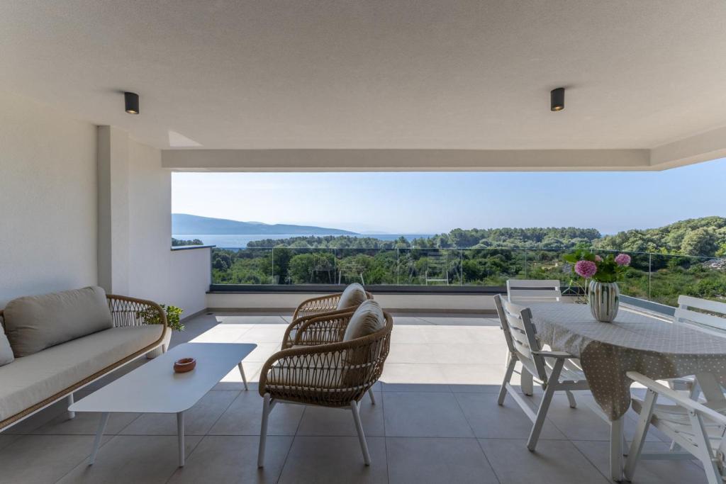 a living room with a couch and a table at Casagrande in Krk