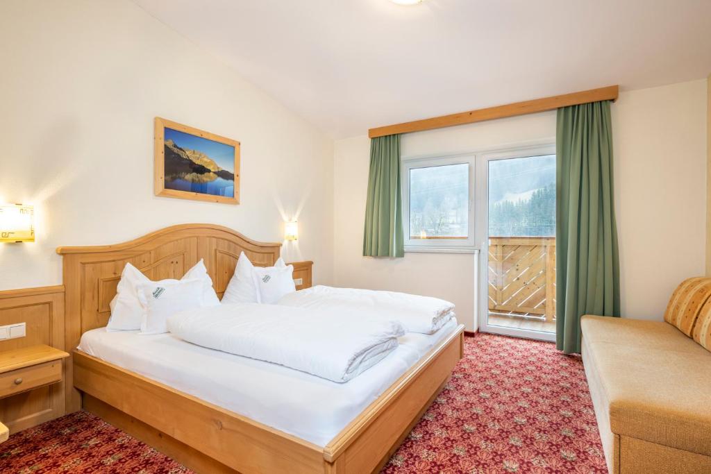 Postel nebo postele na pokoji v ubytování Hotel Brunner - Reiteralm