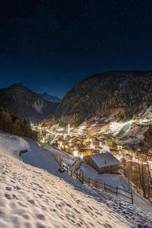 a view of a town in the snow at night at Roma16 in Gerola Alta