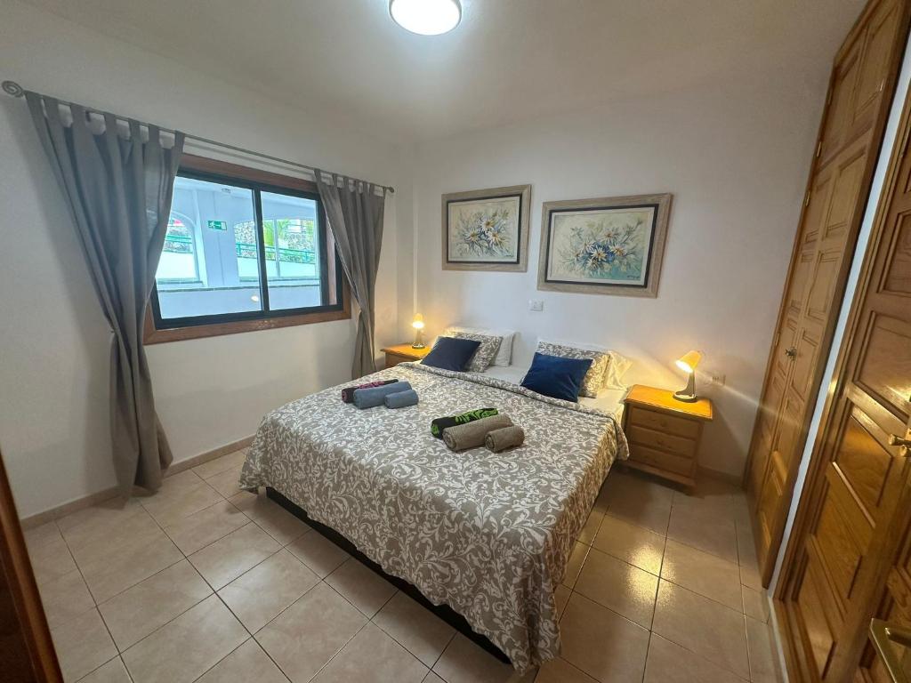 a bedroom with a bed with two pillows on it at Atlantic View Tenerife South in Arona