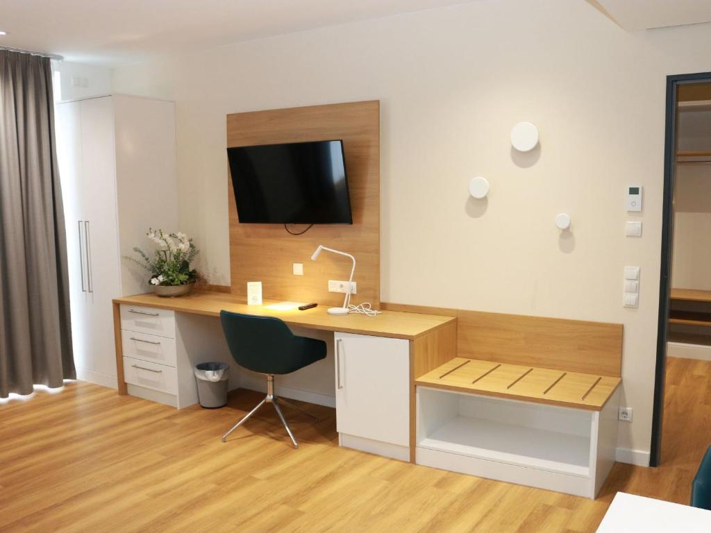 TV a/nebo společenská místnost v ubytování Leben wie im Hotel by Helios