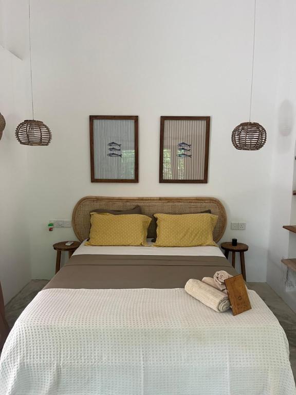 a bedroom with a bed with two towels on it at Maria Bonita Sri Lanka in Ahangama