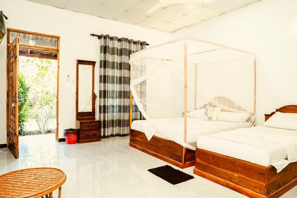 Postel nebo postele na pokoji v ubytování Mithra Paradise Beach Hotel