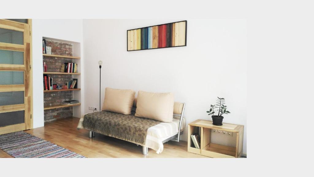 a living room with a chair and a table at Alt Apartament in Sibiu
