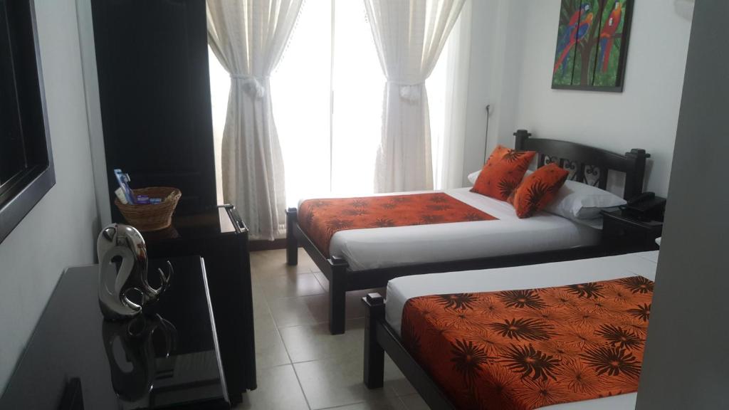 Postel nebo postele na pokoji v ubytování Hotel Colonial