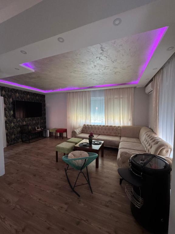a living room with purple lights on the ceiling at Kod Šmece apartmani - Valjevo in Valjevo