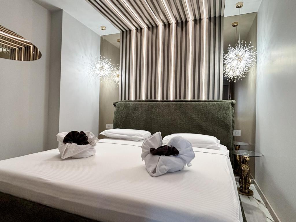a bedroom with a bed with two bags on it at Cloud Nine Airport Residence in Cluj-Napoca